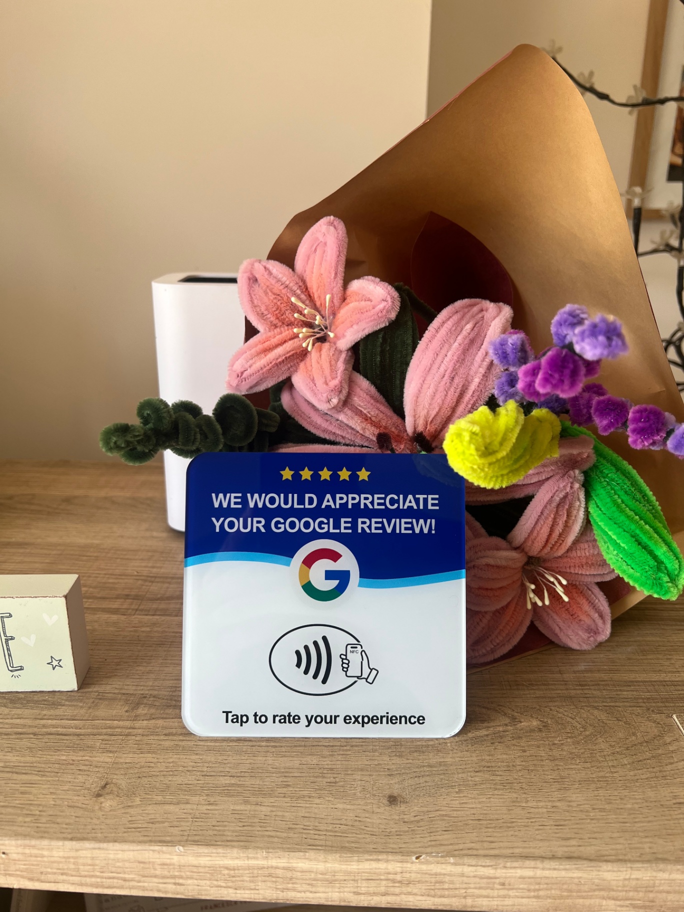 Smartphone showing a Google review page with five stars